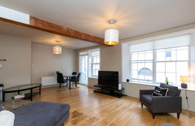 Apartment living and dining room — April 2024 marketing photograph